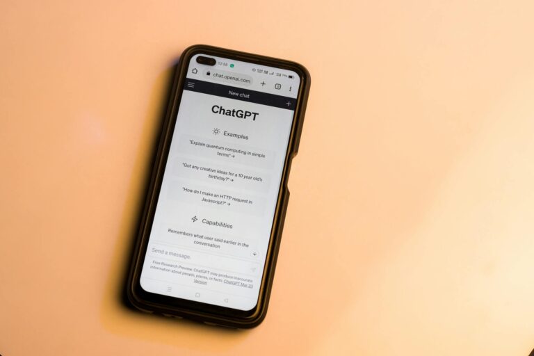 Webpage of ChatGPT, a prototype AI chatbot, is seen on the website of OpenAI, on a smartphone. Examples, capabilities, and limitations are shown.